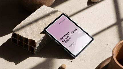 ClimatePartner's Corporate Carbon Footprint Report on a tablet