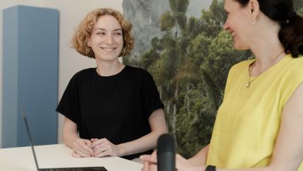 Two people being filmed in a studio