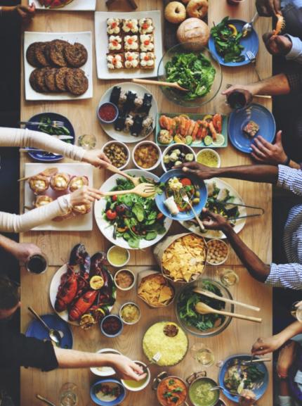 Table with many dishes filled with various food