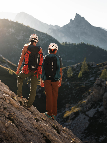 Two hikers on a mountain with ORTOVOX backpacks
