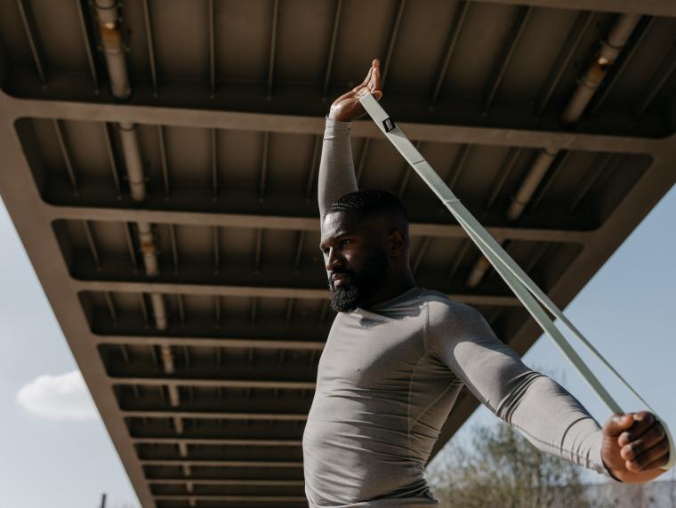 Ein Mann trainiert mit einem Fitnessband von BLACKROLL