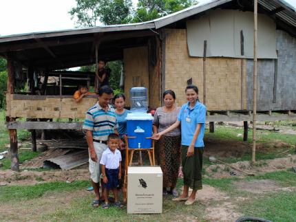 A family in Laos receives a ceramic water filter