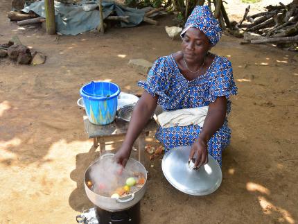 Women cooking with improved cookstove