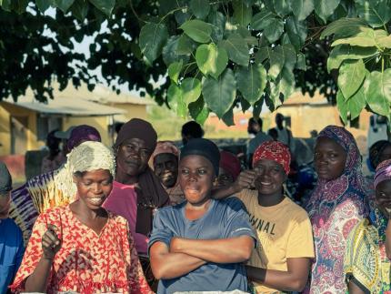 Women standing in front of biochar