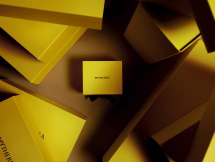 Yellow boxes branded with Mytheresa