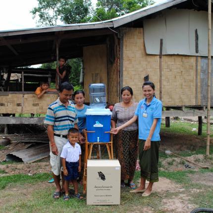 A family in Laos receives a ceramic water filter