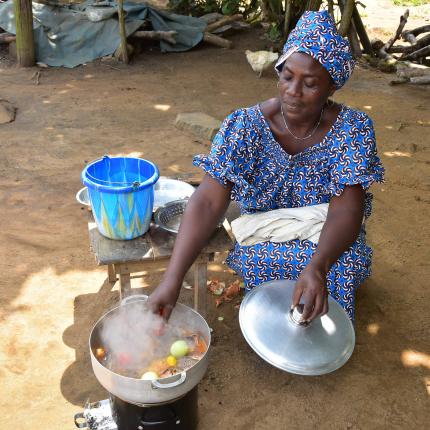 Women cooking with improved cookstove