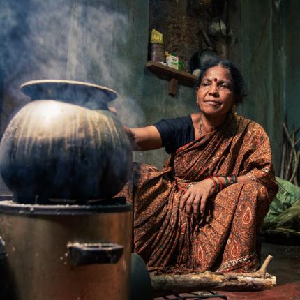 Women cooking with improved cookstove