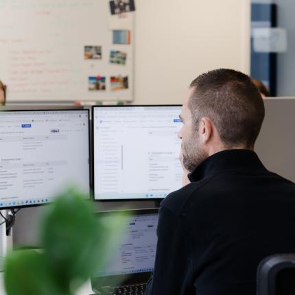 man sitting in front of screen