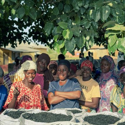 Women standing in front of biochar