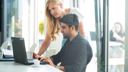 business two people sitting in front of laptop