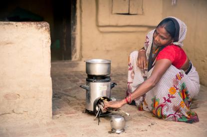 indian woman firing a cookstove