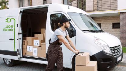 Mann belädt Transporter mit Paketen