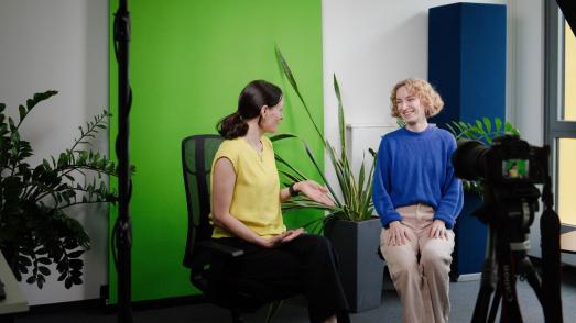 two women talking infront of a camera
